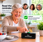 An older woman at a wooden table presses a black MedClock reminder device. The scene includes a green notification bubble reading 'MedClock Mum has acknowledged her 8am reminder.